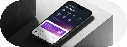 Smartphone displaying a financial app dashboard on a marble surface